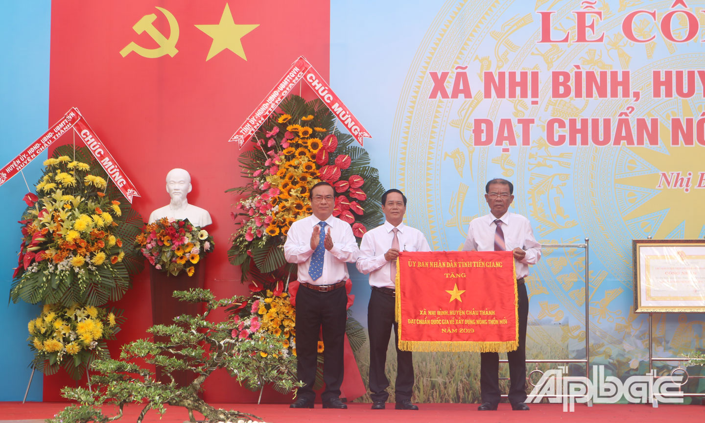 Đồng chí Phạm Anh Tuấn tặng Cờ thi đua của UBND tỉnh cho lãnh đạo xã Nhị Bình.