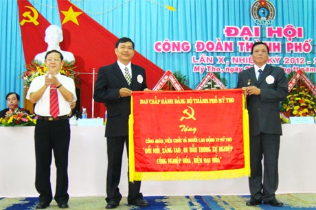 Bí thư Thành ủy Huỳnh Đức Minh trao tặng Bức trướng cho đại diện Ban Thường vụ LĐLĐ TP. Mỹ Tho.
