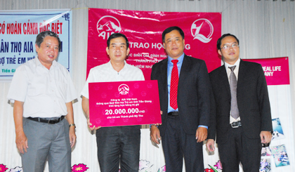 Đại diện AIA Việt Nam trao bảng tượng trưng 20 triệu đồng cho đại diện lãnh đạo tỉnh Tiền Giang.