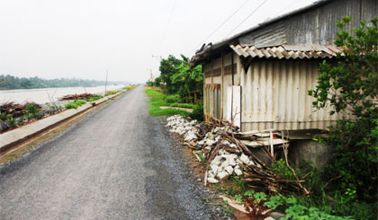 Nhà ông Hoàng vẫn chưa tháo dỡ, trong khi đường và kè kinh Chợ Gạo (đoạn qua nhà ông Hoàng) đã thực hiện xong.