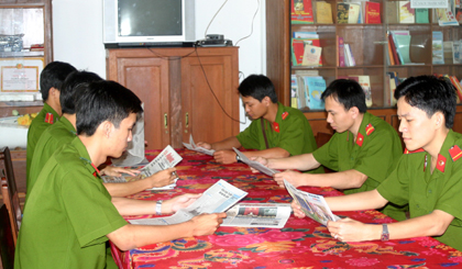 Cán bộ, chiến sĩ CA huyện Châu Thành đọc báo buổi sáng.  	Ảnh: PHÙNG LONG