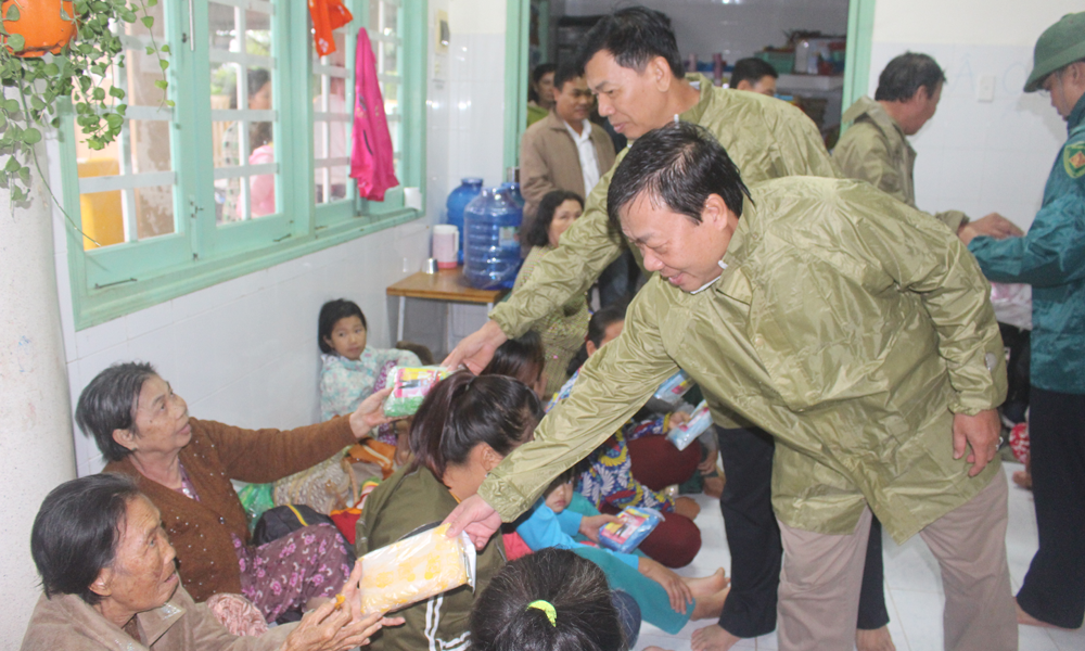 Phát áo mưa cho người dân về nhà.