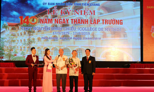 Hiệu trưởng nhà trường tặng hoa tri ân với 2 cựu học sinh lão thành cách mạng. 