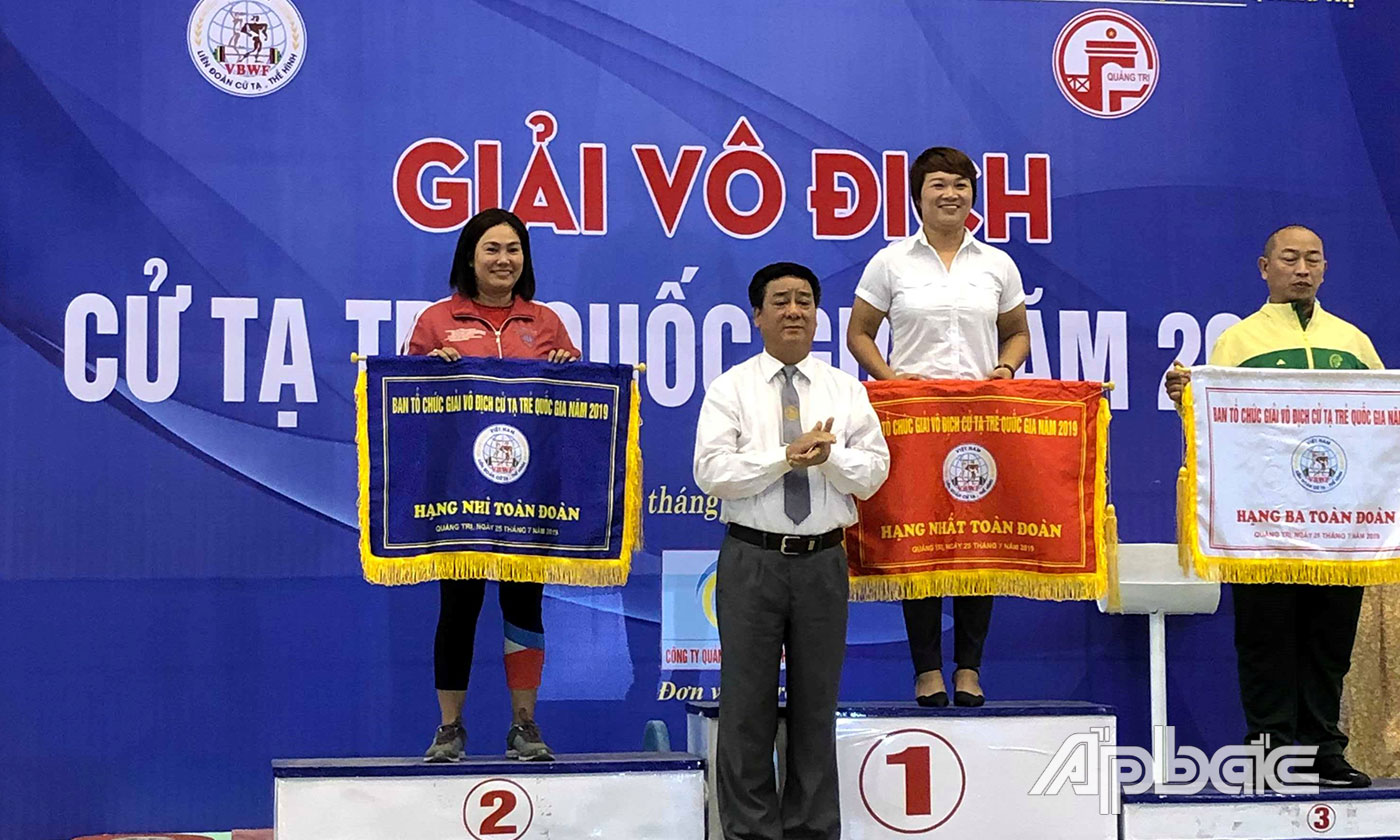 Huấn luyện viên Nguyễn Thụy Khương (bên trái) nhận Cờ hạng Nhì toàn đoàn tại Giải Vô địch Cử tạ trẻ quốc gia năm 2019.
