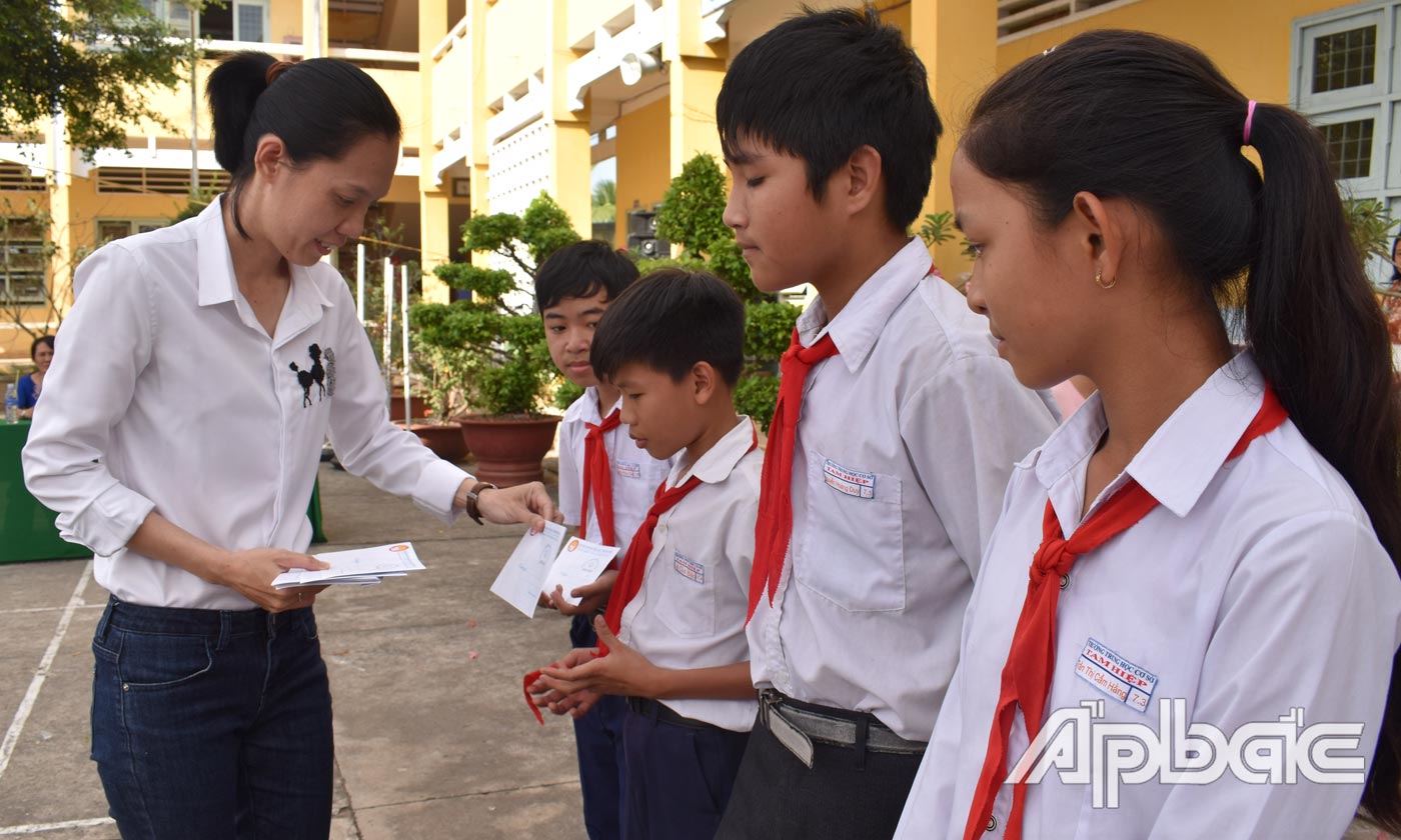 Đại diện Qỹ từ thiện Lương Ngọc Kim trao học bồng cho học sinh.