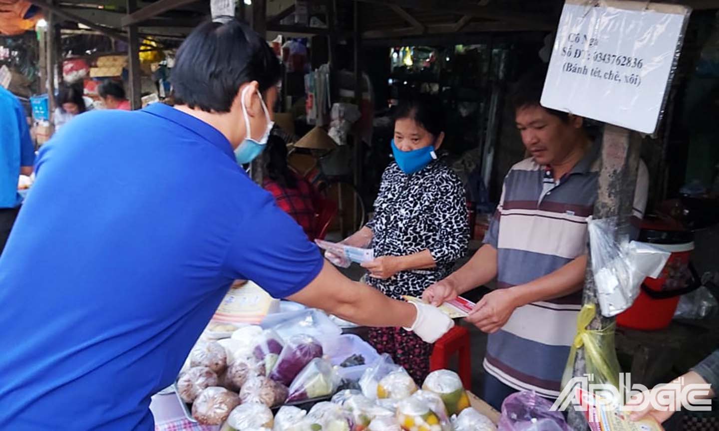 Đoàn viên phát tờ rơi tuyên truyền phòng chống dịch ở huyện Chợ Gạo.