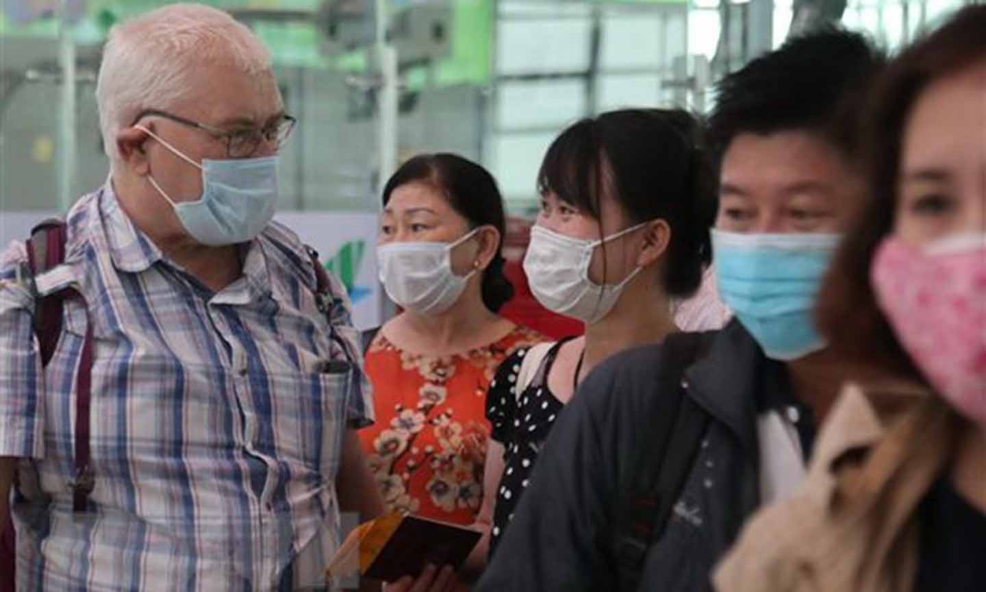 Du khách tự bảo vệ mình bằng cách đeo khẩu trang tại Cảng hàng không Quốc tế Vinh. (Ảnh: Bích Huệ/TTXVN)