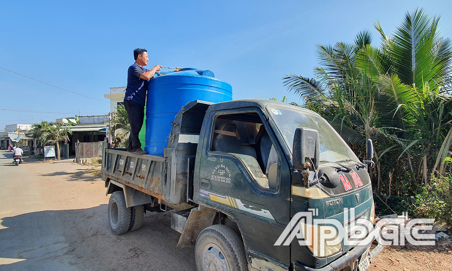 Anh Hiếu bên chiếc xe tải vận chuyển nước sinh hoạt miễn phí cho người dân. 