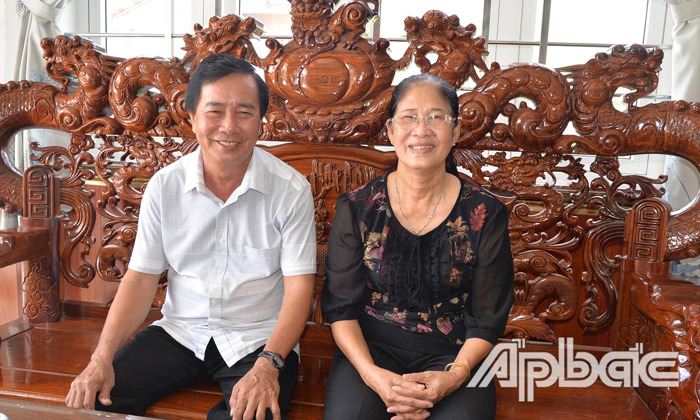 Vợ chồng chú Phụng bên ngôi nhà khang trang. 