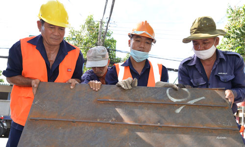Đồng tâm hiệp lực để mở nắp cống.