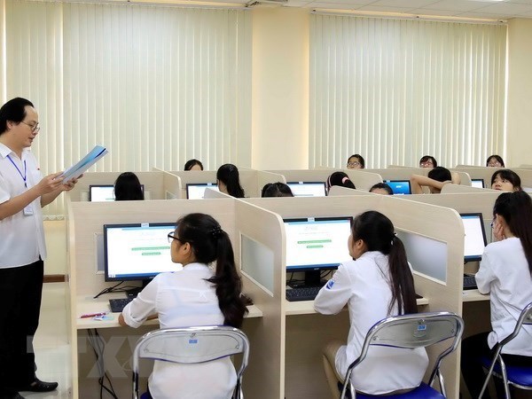 Giám thị phổ biến quy chế thi cho thí sinh trước giờ làm bài thi đánh giá năng lực môn Ngoại ngữ trên máy tính tại Đại học Quốc gia Hà Nội. (Ảnh: Quý Trung/TTXVN)