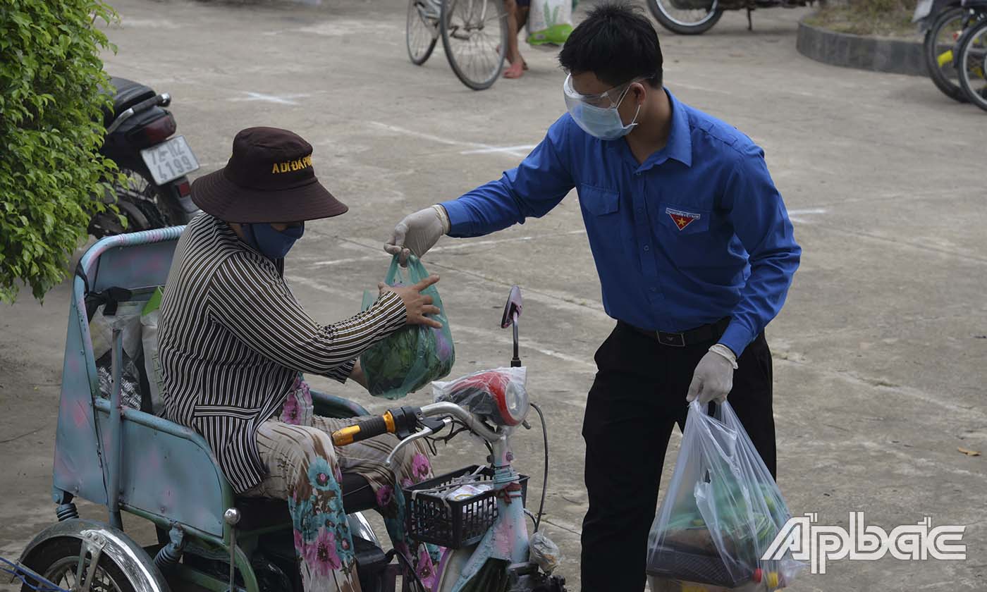 Đoàn viên hô trợ giao hàng cho người khuyết tật đến
