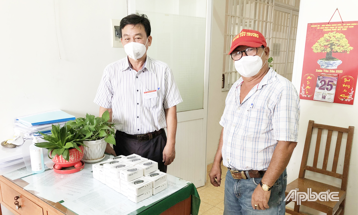 Bác sĩ Nguyễn Văn Trạng (bên trái) tiếp nhận máy từ Nhóm san sẻ yêu thương TP. Mỹ Tho trao tặng