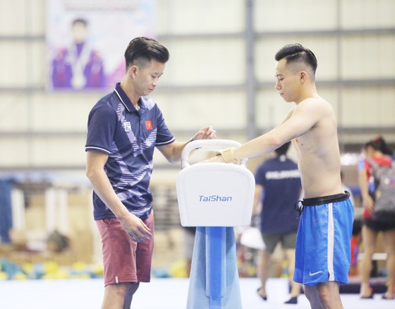 HLV Trương Minh Sang và VĐV Lê Thanh Tùng tập luyện.