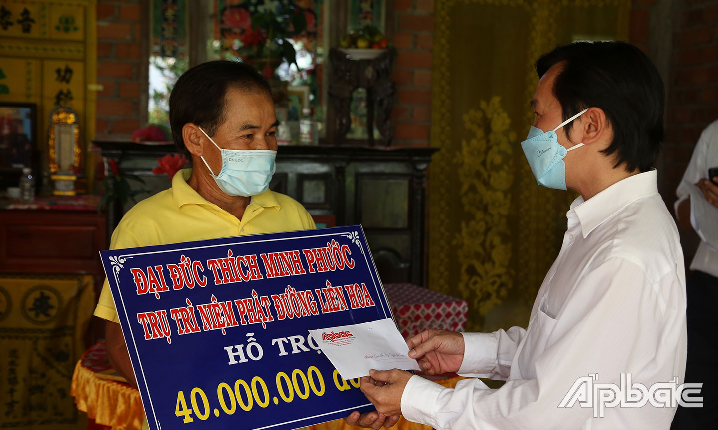 Phó Tổng Biên tập Báo Ấp Bắc đại diện Tổ từ thiện Báo Ấp Bắc trao số tiền bạn đọc.