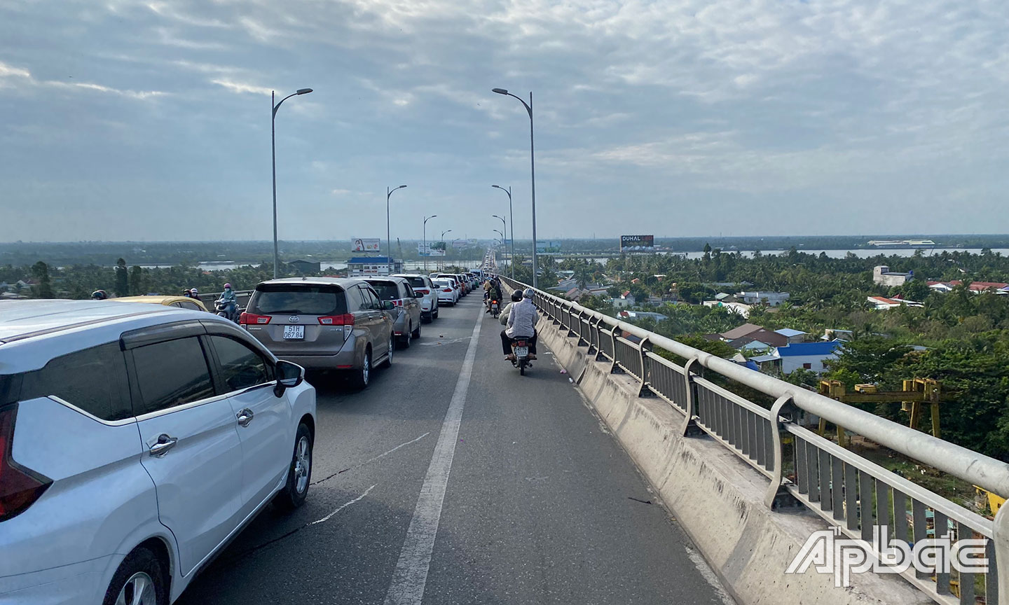 Các phương tiện ô tô nối đuôi nhau qua cầu Rạch Miễu.