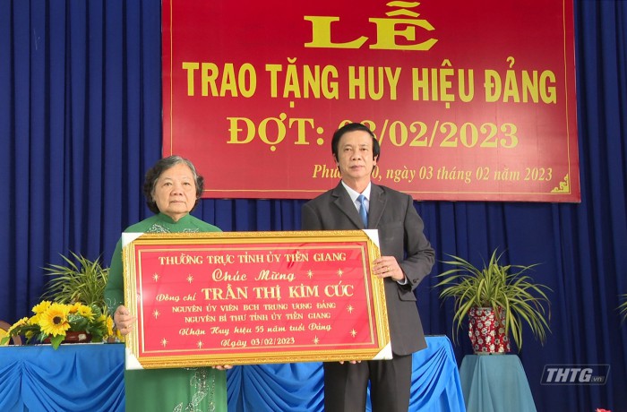 Ông Nguyễn Văn Danh, Ủy viên Trung ương Đảng, Bí thư Tỉnh ủy trao huy hiệu 55 tuổi Đảng cho bà Trần Thị Kim Cúc. Ảnh: Minh Nguyên