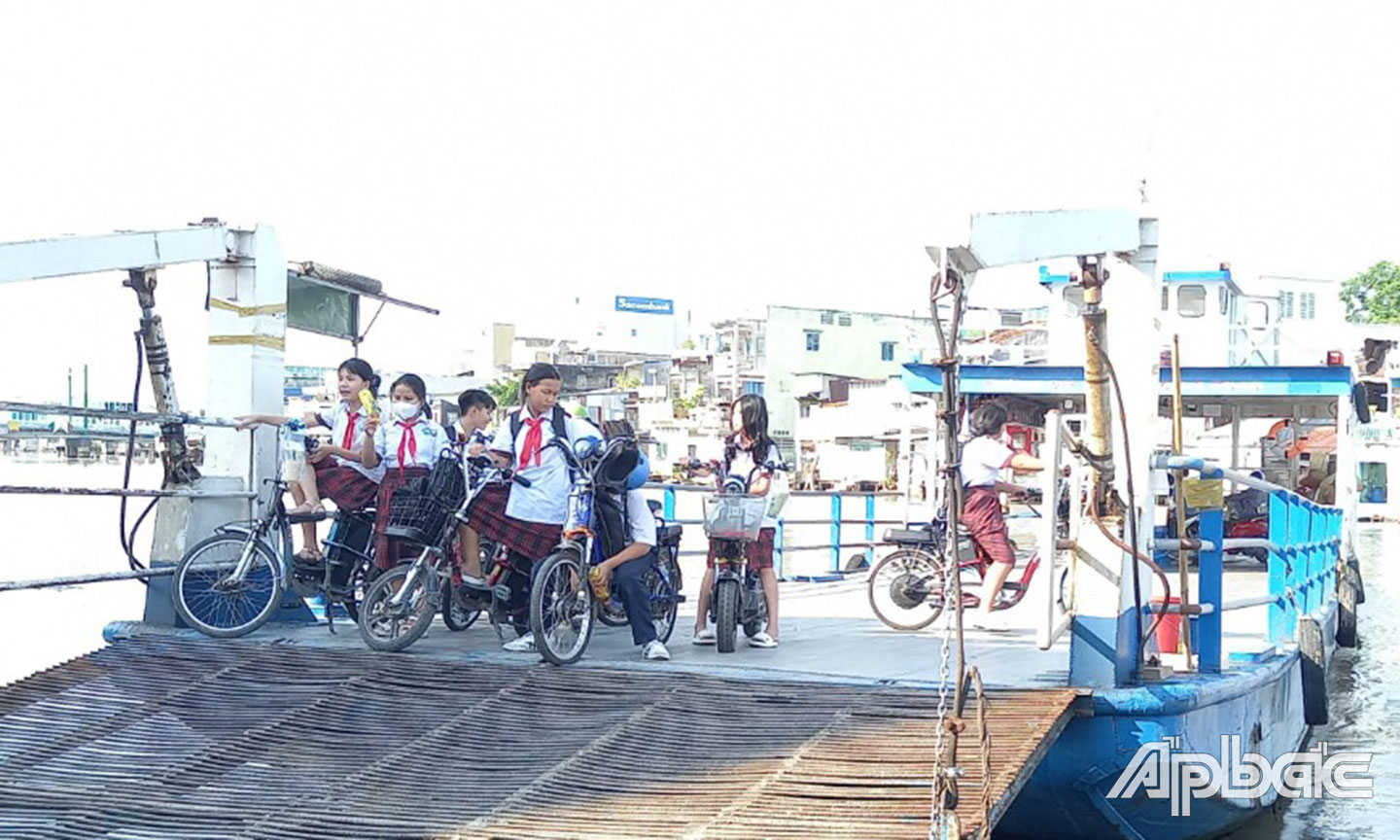 Học sinh qua phà Tân Long (TP. Mỹ Tho) không rào chắn, không áo phao, không đội nón bảo hiểm.