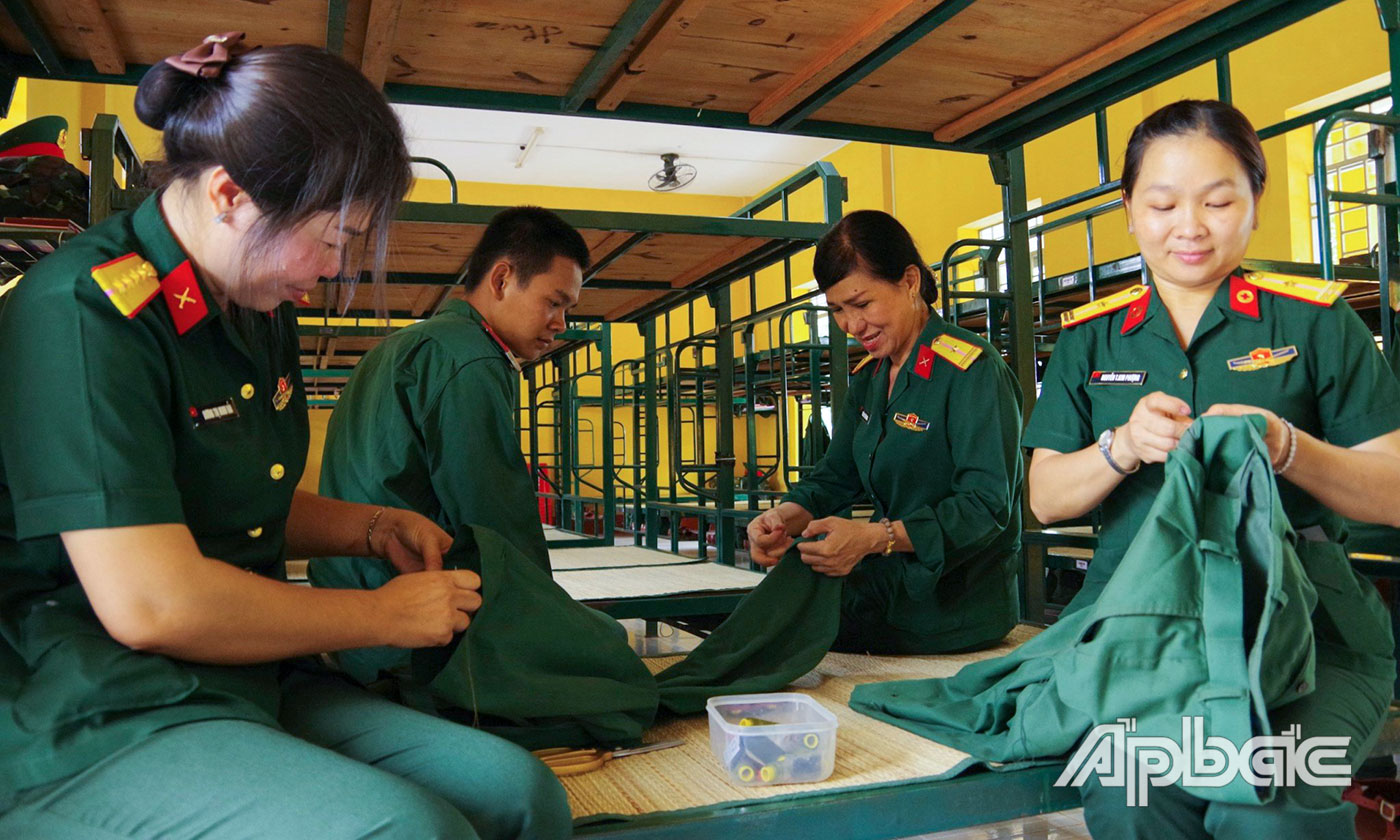 Cán bộ, hội viên Hội Phụ nữ cơ sở Phòng Chính trị trực tiếp đến các Đại đội để may vá, gắn cúc áo cho chiến sĩ mới Tiểu đoàn 5, Trung đoàn 2.