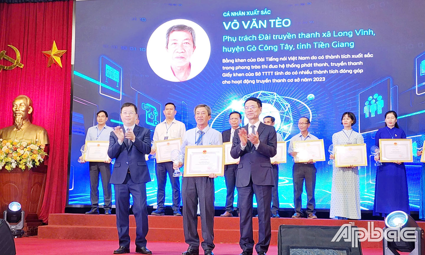 Bộ trưởng Bộ TT&TT Nguyễn Mạnh Hùng và Thứ Trưởng  Bộ TT&TT Nguyễn Thanh Lâm trao Bằng khen và biểu trưng cho ông Võ Văn Tèo tại hội nghị.