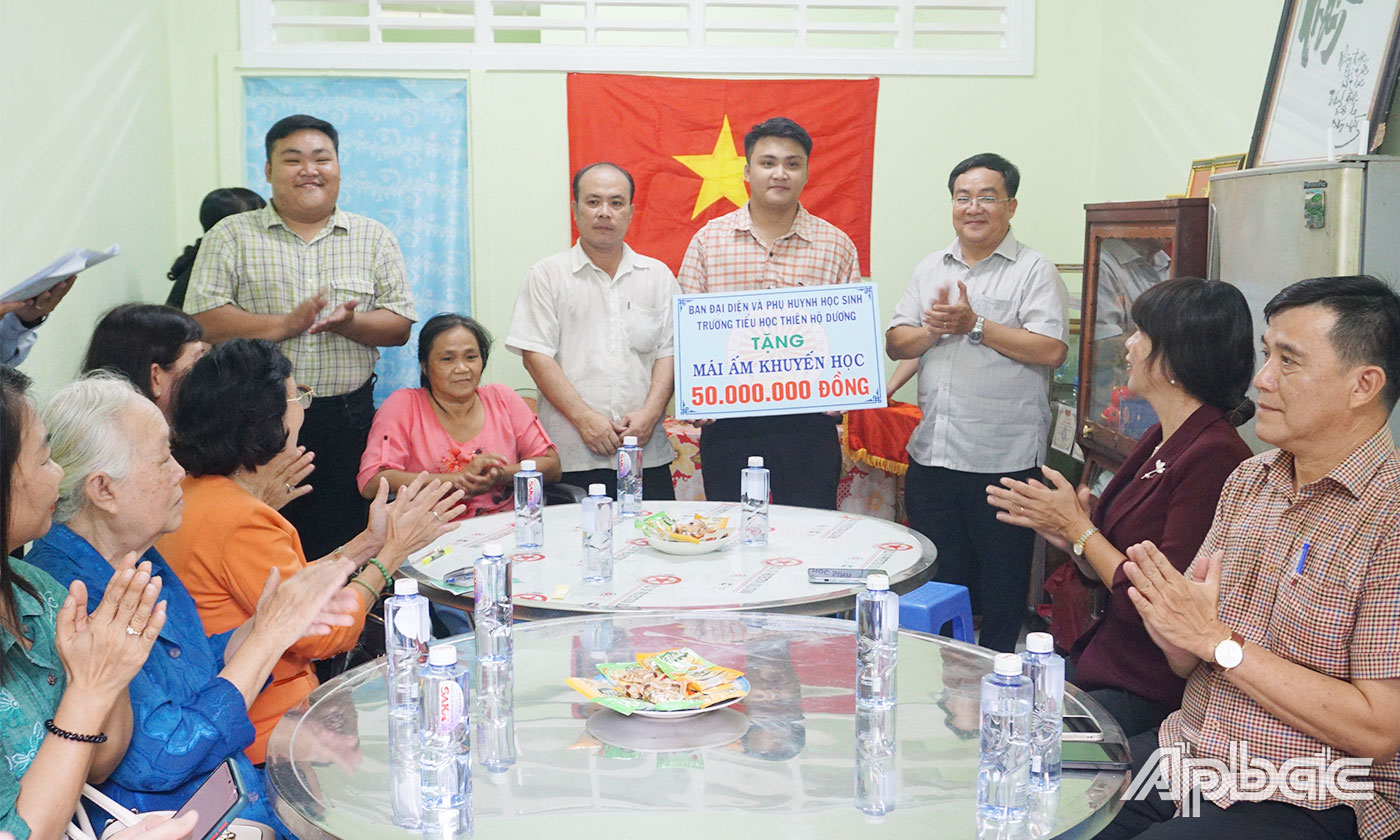 Ban Đại diện PHHS và Cha mẹ PHHS trường Tiểu học Thiên Hộ Dương trao Bảng tượng trưng Mái ấm khuyến học cho em Phạm Võ Minh Thông. 
