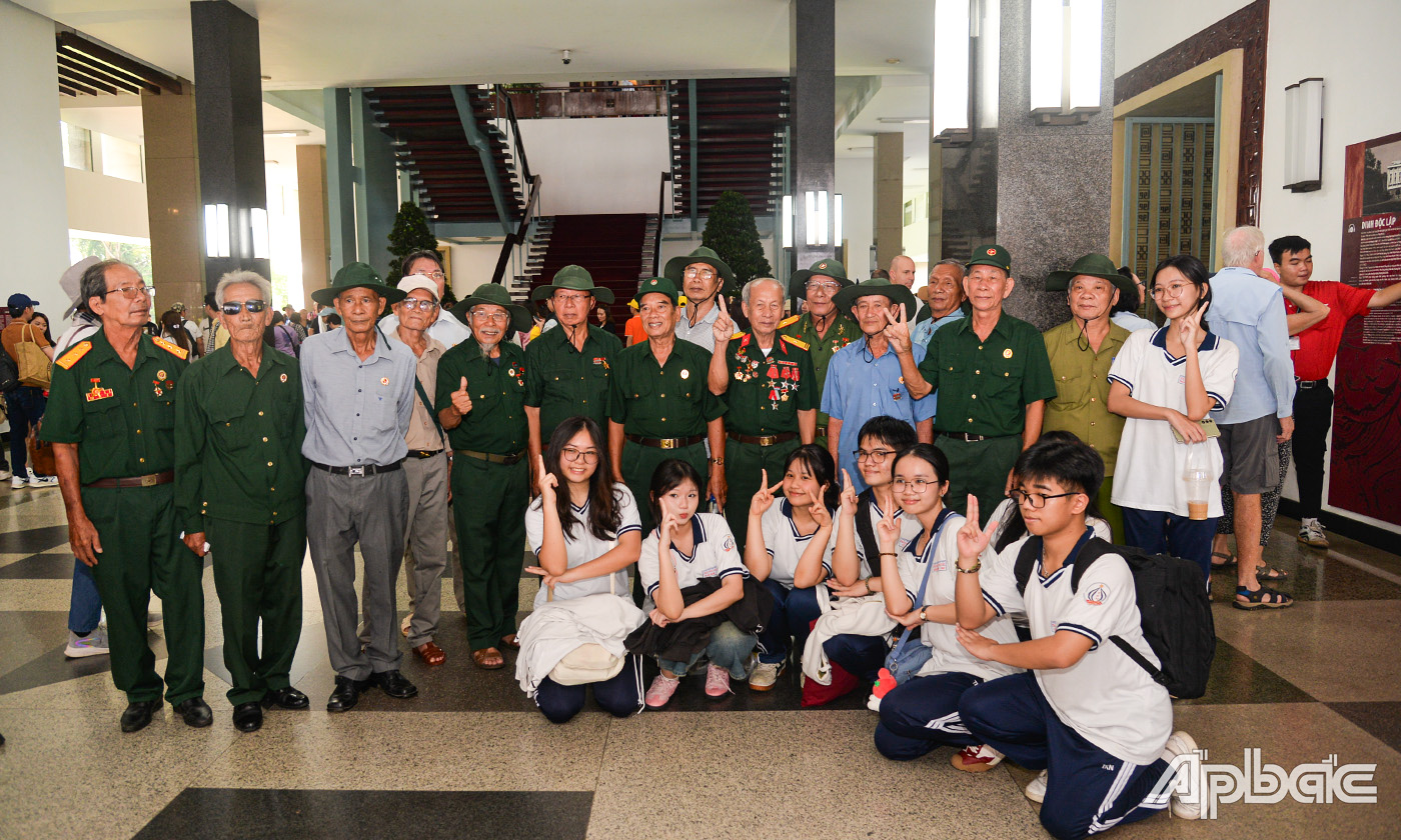 Học sinh giao lưu và chụp ảnh lưu niệm với các cựu chiến binh tỉnh Tiền Giang trực tiếp tham gia chiến dịch lịch sử góp phần làm nên đại thắng mùa Xuân 1975.