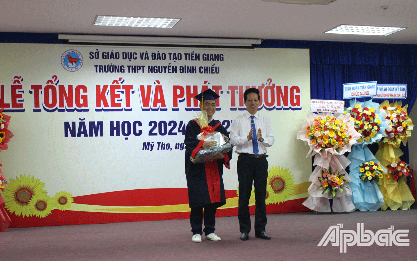Phó Chủ tịch UBND tỉnh Nguyễn Thành Diệu khen thưởng cho học sinh xuất sắc toàn diện của trường. 