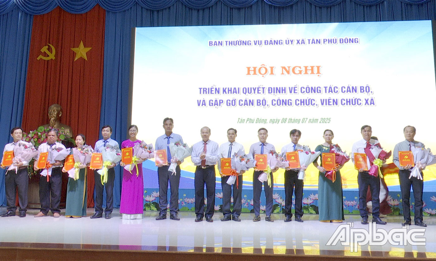 Đồng chí Lê Thanh Đằng, Chủ tịch UBND xã Tân Phú Đông trao quyết định và tặng hoa lãnh đạo các cơ quan giúp việc Ban Thường vụ Đảng ủy xã Tân Phú Đông.